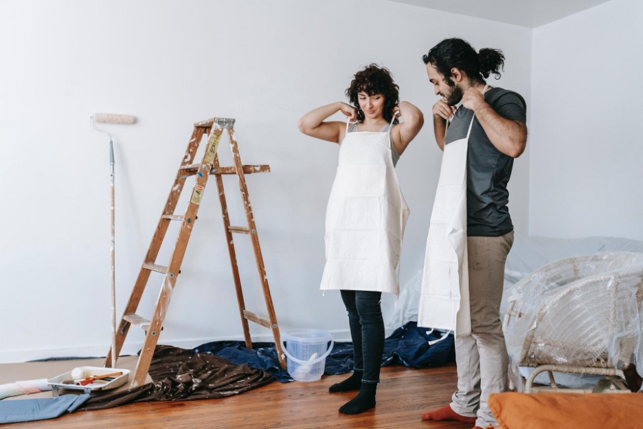 A couple prepares to paint a room.